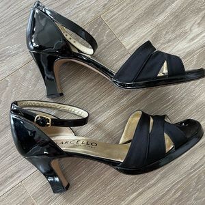 Black patent leather. Part of shoe that goes over front is different material.